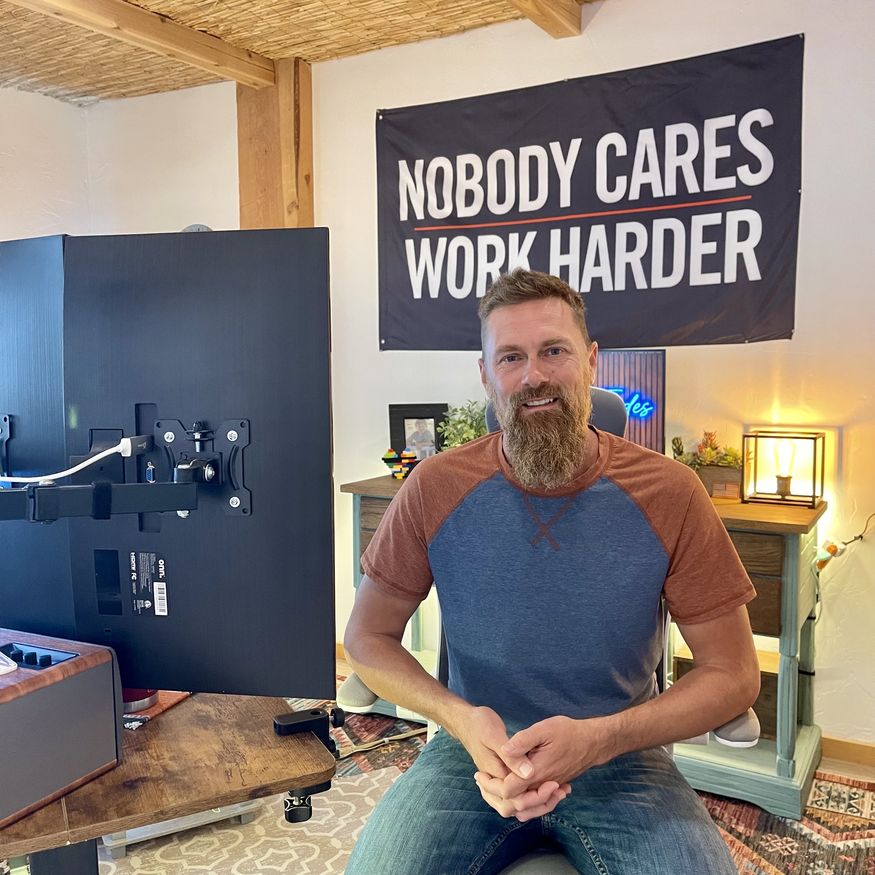 Bret James in his Durango office beneath the Nobody Cares Work Harder sign