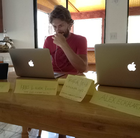Bret James working between two laptops at a shared table